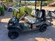 Black golf cart with white and black striped seats at 13816 Messina Loop # 203, Bradenton, FL 34211