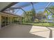 Large screened patio with a view of the backyard and lake at 4978 Cedar Oak Way, Sarasota, FL 34233