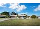 Single story home with a dark brown garage door and lush green lawn at 633 Chevy Chase Dr, Sarasota, FL 34243