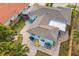 Aerial view of the backyard with a deck, patio, and meticulous landscaping at 745 Bruce Ave, Clearwater Beach, FL 33767