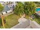 Aerial view of a backyard featuring an outdoor patio, outdoor seating, and lush landscaping at 745 Bruce Ave, Clearwater Beach, FL 33767