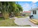 Backyard features a brick paver patio, grill, dining area, and mature landscaping at 745 Bruce Ave, Clearwater Beach, FL 33767