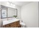 Elegant half bathroom features a rustic vanity, quartz countertop, and decorative mirror at 745 Bruce Ave, Clearwater Beach, FL 33767