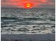 Beautiful sunset over the water on a beach with crashing waves at 745 Bruce Ave, Clearwater Beach, FL 33767
