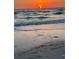 Coastal beach view at sunset with gentle waves washing onto the sandy shore at 745 Bruce Ave, Clearwater Beach, FL 33767
