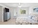 Bright bedroom featuring coastal-themed bedding, light wood floors, and ample natural light at 745 Bruce Ave, Clearwater Beach, FL 33767