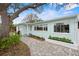 Charming home with a neatly landscaped walkway and light blue exterior paint at 745 Bruce Ave, Clearwater Beach, FL 33767