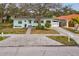 Charming home featuring a lovely paver driveway, mature tree, and freshly painted exterior at 745 Bruce Ave, Clearwater Beach, FL 33767