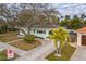 Charming home with a well-manicured lawn, mature trees, and inviting entrance at 745 Bruce Ave, Clearwater Beach, FL 33767