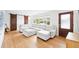 Bright living room featuring hardwood floors, a sliding barn door, and a comfortable sectional at 745 Bruce Ave, Clearwater Beach, FL 33767