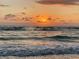 Idyllic ocean view at sunset with soft, rolling waves and a partly cloudy sky at 745 Bruce Ave, Clearwater Beach, FL 33767