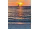 Picturesque sunset over the water with a sailboat silhouetted against the vibrant sky at 745 Bruce Ave, Clearwater Beach, FL 33767
