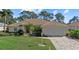 One-story home with tile roof, landscaped yard, and two-car garage at 8111 Fairhaven Glen, University Park, FL 34201