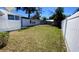 Spacious backyard with a grassy area and a white fence at 3642 Dartmouth N Ave, St Petersburg, FL 33713