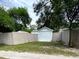 Detached garage with white door, located behind a fence at 3642 Dartmouth N Ave, St Petersburg, FL 33713