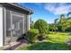 Landscaped backyard with a screened patio at 5397 Bartolomeo St, Sarasota, FL 34238