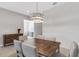 Elegant dining area with a wood table, gray chairs, and shiplap accent wall at 5397 Bartolomeo St, Sarasota, FL 34238