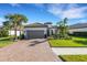 One-story house featuring a gray garage door and lush landscaping at 5397 Bartolomeo St, Sarasota, FL 34238