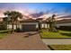 Single-story home with a gray garage door and landscaped lawn at 5397 Bartolomeo St, Sarasota, FL 34238