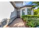 Inviting front entry with a dark brown door, stone accents, and neatly landscaped walkway at 5397 Bartolomeo St, Sarasota, FL 34238