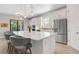 Modern kitchen boasting white cabinets, a sizable island, and stainless steel appliances at 5397 Bartolomeo St, Sarasota, FL 34238