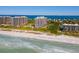 Aerial view of luxurious beachfront condo building with resort amenities at 1211 Gulf Of Mexico Dr # 408, Longboat Key, FL 34228