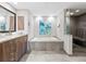 Spa-like bathroom with soaking tub, walk-in shower, and modern vanity at 1211 Gulf Of Mexico Dr # 408, Longboat Key, FL 34228