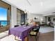 Bright dining area with ocean view, table set for a meal, and living room visible at 1211 Gulf Of Mexico Dr # 408, Longboat Key, FL 34228