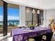 Bright dining room with ocean views and a table set for dinner at 1211 Gulf Of Mexico Dr # 408, Longboat Key, FL 34228