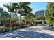Gated entrance to community with lush landscaping and palm trees at 1211 Gulf Of Mexico Dr # 408, Longboat Key, FL 34228