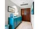 Bright and spacious entryway with blue console table and modern art at 1211 Gulf Of Mexico Dr # 408, Longboat Key, FL 34228