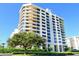 High-rise beachfront building with lush landscaping at 1211 Gulf Of Mexico Dr # 408, Longboat Key, FL 34228