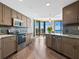 Modern kitchen with granite countertops and stainless steel appliances and ocean view at 1211 Gulf Of Mexico Dr # 408, Longboat Key, FL 34228