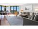 Spacious living room with hardwood floors, large windows, and ocean views at 1211 Gulf Of Mexico Dr # 408, Longboat Key, FL 34228