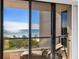 Stunning ocean view from a condo balcony, featuring lounge chairs and telescope at 1211 Gulf Of Mexico Dr # 408, Longboat Key, FL 34228