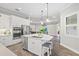 Open concept kitchen with island, stainless steel appliances, and white cabinetry at 13021 Indigo Way, Bradenton, FL 34211