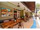 Outdoor patio dining with copper-topped tables and sidewalk seating at 13021 Indigo Way, Bradenton, FL 34211