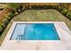 Inviting rectangular pool with concrete deck and fenced yard at 2554 Arlington St, Sarasota, FL 34239