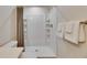 Clean bathroom with a shower, shelves, and fresh towels at 1006 Hagle Park Rd, Bradenton, FL 34212