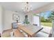 Dining room with sliding glass doors to backyard and wood dining table at 1006 Hagle Park Rd, Bradenton, FL 34212