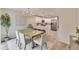 Open concept dining room with modern chandelier and view into kitchen at 1006 Hagle Park Rd, Bradenton, FL 34212