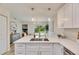 Modern kitchen with white cabinetry, a large island, and stainless steel appliances at 1006 Hagle Park Rd, Bradenton, FL 34212