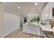 Modern kitchen with white cabinets, stainless steel appliances, and quartz countertops at 1006 Hagle Park Rd, Bradenton, FL 34212