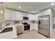 Modern kitchen with white cabinets, stainless steel appliances, and quartz countertops at 1006 Hagle Park Rd, Bradenton, FL 34212