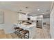 Modern kitchen with white cabinets, breakfast bar, and stainless steel appliances at 1006 Hagle Park Rd, Bradenton, FL 34212