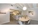 Dining room with light wood table and white chairs, open to kitchen at 4844 Brywill Cir, Sarasota, FL 34234