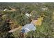 Aerial view of a house with a gray roof in a wooded area at 7146 Territory Ln, Sarasota, FL 34240