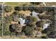 Aerial view showing home, pool, and outbuildings on the property at 7146 Territory Ln, Sarasota, FL 34240