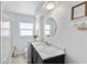 Elegant bathroom with a marble countertop, modern vanity, and bathtub at 7146 Territory Ln, Sarasota, FL 34240