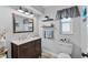 Modern bathroom with floating shelves, updated vanity, and window at 7146 Territory Ln, Sarasota, FL 34240